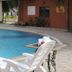 Seven Sky Clarks Exotica, Bhuj: outdoor pool with lounge chair and table beside the water