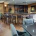Comfort Suites Texarkana lounge with bar stools, high-top table, and stone-accented counter