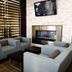 Holiday Inn & Suites Red Deer South lobby seating area with fireplace and wall-mounted TV