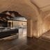 Áurea Toledo by Eurostars Hotel company interior with arched brick hall and lounge seating in Toledo