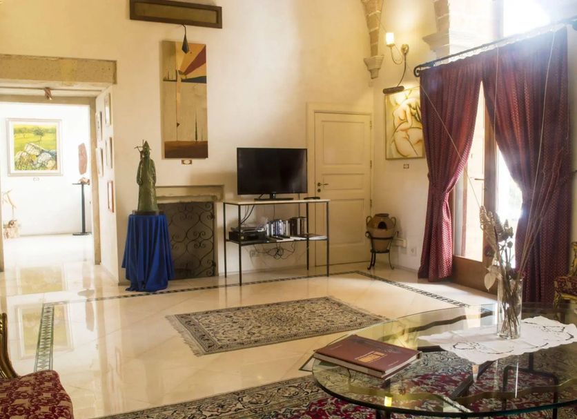 Residence Palazzo Baldi in Galatina: elegant lobby lounge with high ceilings, TV, area rug, and large curtains