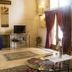 Residence Palazzo Baldi in Galatina: elegant lobby lounge with high ceilings, TV, area rug, and large curtains