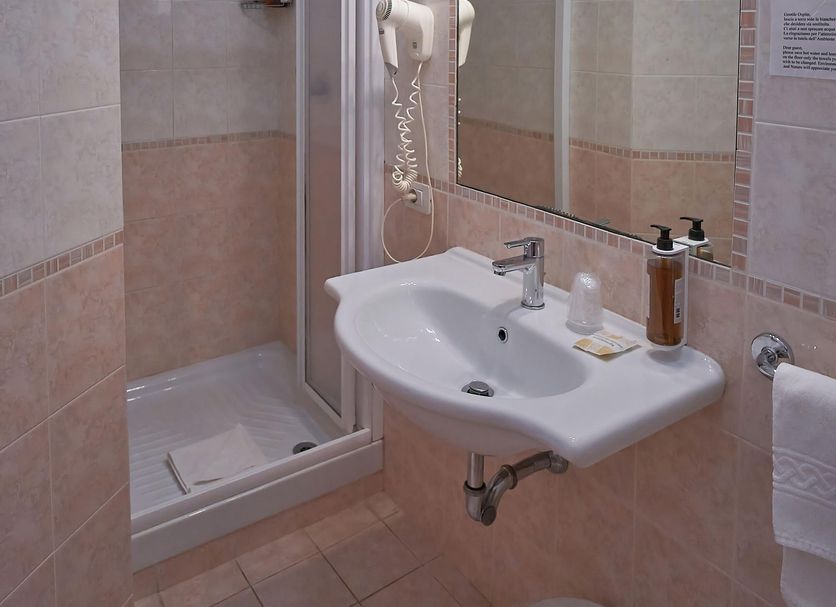 Bel Sole Civitavecchia bathroom with shower, sink, mirror and wall lights