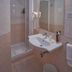 Bel Sole Civitavecchia bathroom with shower, sink, mirror and wall lights