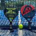 Female Resort in San Felice Circeo: two padel rackets and a ball against a court net