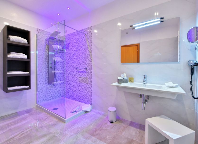 Hotel d'Altavilla bathroom in Canosa di Puglia with glass shower, vanity sink and wall mirror