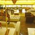 Garden Hotel in Campina Grande lounge with sofas, tables and a red decorative wheel display