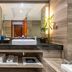 Manhattan Kinlen Hotel Shishi in Quanzhou bathroom vanity with sink, mirror, towels, and toiletries