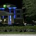 Holiday Inn Express & Suites Brooksville West by IHG exterior at night with blue-lit entrance