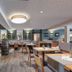 Hotel Halfenstube & Villa Spa 1894 in Briedern: modern hotel restaurant with wooden tables and bar seating