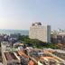 Many Holiday The Base Condo Pattaya balcony view with city skyline and distant sea