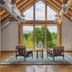Wildflower Farms, Auberge Collection in Gardiner lounge with two chairs facing large windows and mountain view