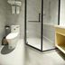 Tizi Hostel Shanghai bathroom with glass-enclosed shower, toilet, towel shelf and vanity