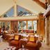 Faraway Jackson Hole in Teton Village lounge with stone fireplace, vaulted windows and mountain views