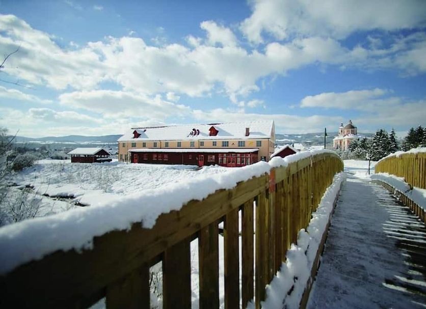Hotel Jufa Poellau in Pöllauberg with a snowy walkway and distant winter landscape
