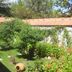 Hotel Baykal in Bogazkale garden with flowering shrubs and terracotta-roofed buildings