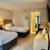 Doolan's Shore Club in Spring Lake Heights: guest room with two double beds, lamp, dresser and hallway