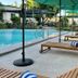La Planta Hotel And Restaurant in Bais City: poolside loungers with umbrellas beside the outdoor pool