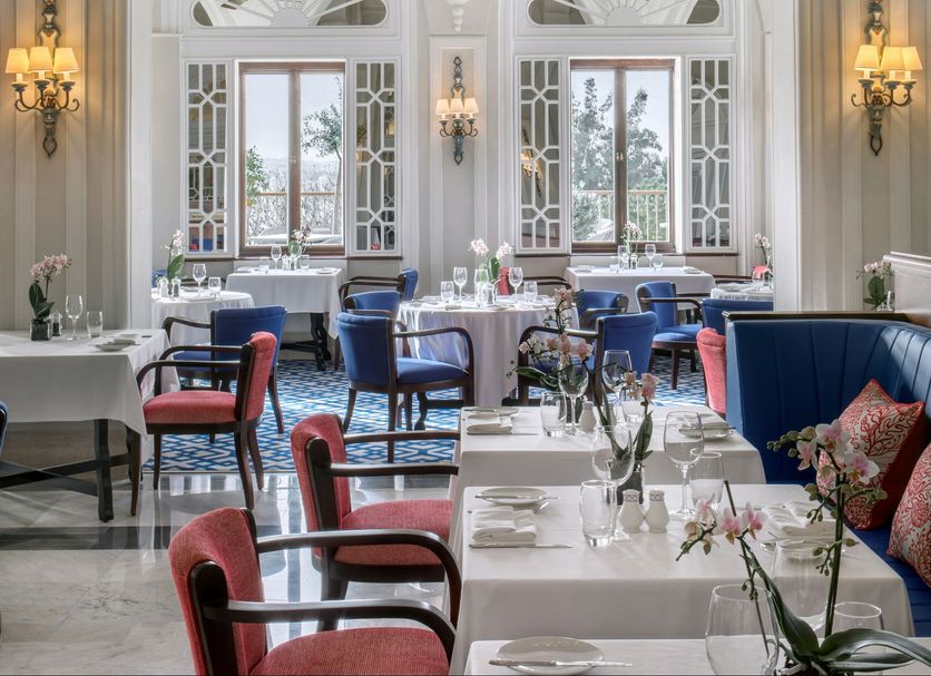The Phoenicia Malta in Valletta, elegant restaurant dining room with chandeliers and tall arched windows