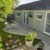 Bramlies in Dorchester with a patio seating area beside a cottage-style exterior and garden