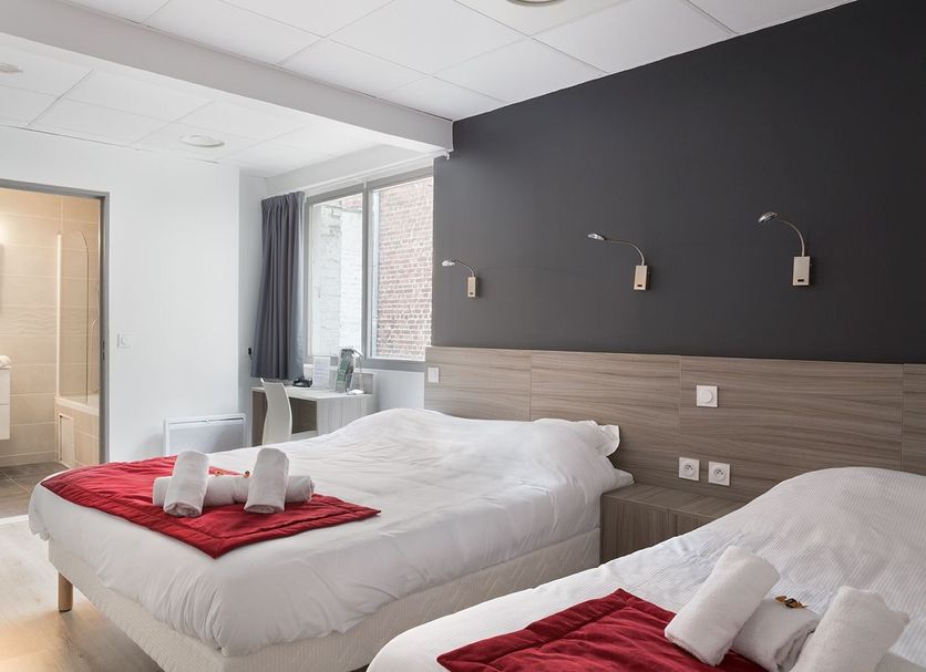 Lille City Hotel in Lille guest room with two single beds, bathroom doorway, and window view