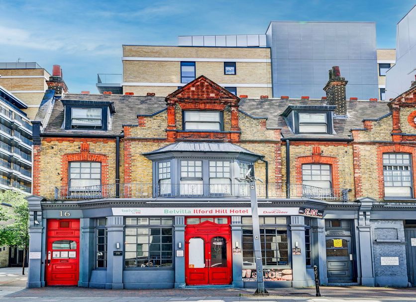 Belvilla Ilford Station Hotel in Ilford, historic brick facade with red doors and dormer windows