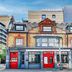 Belvilla Ilford Station Hotel in Ilford, historic brick facade with red doors and dormer windows