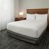 TownePlace Suites by Marriott San Jose Campbell guest room with king bed and bedside lamps