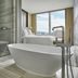 Four Seasons Hotel One Dalton Street, Boston bathroom with freestanding tub, walk-in shower and city view