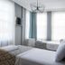 Luna Boutique Hotel Antalya guest room with two beds and tall windows