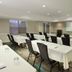 Meeting room at Residence Inn by Marriott Colorado Springs North/Air Force Academy with tables, chairs and projector screen