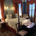 1842 Inn in Macon guest room with four-poster bed, fireplace, and classic sitting area