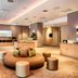Leonardo Hotel Wolfsburg City Center lobby lounge with circular seating and buffet area in Wolfsburg