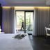 A Point Porto Ercole Resort & Spa room with bed, desk, and balcony doors in Porto Ercole