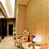 Rota Bulvar Hotel Ankara hallway with ornate chairs, patterned wallpaper and modern ceiling lights