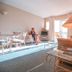 Il Palazzo Holiday Apartments Cairns living area with sofa, lamp, glass table and balcony view