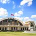 The Heritage Sathorn Suite Hotel Bangkok exterior with grand arched facade and Thai flag