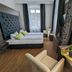 Badhotel Bad Brückenau guest room with twin beds, armchair, and window view in Bad Brueckenau
