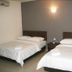 Jb City Hotel Johor Bahru guest room with two beds, bedside table, and wall light