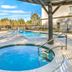 La Quinta Inn & Suites by Wyndham Mobile Satsuma/Saraland pool area with hot tub and outdoor seating in Satsuma