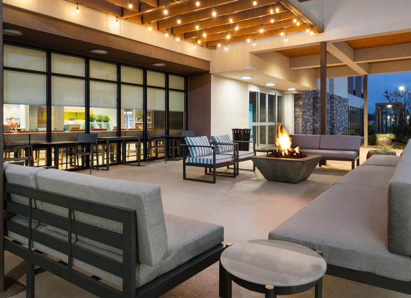 Home2 Suites by Hilton Alexandria patio lounge with fire pit and cushioned seating