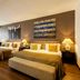 Quentin Boutique Hotel Berlin guest room with two beds, bench seating, and large window