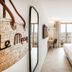 Le Mirage in Bormes-les-Mimosas room with balcony view, king bed and woven wall bag decor