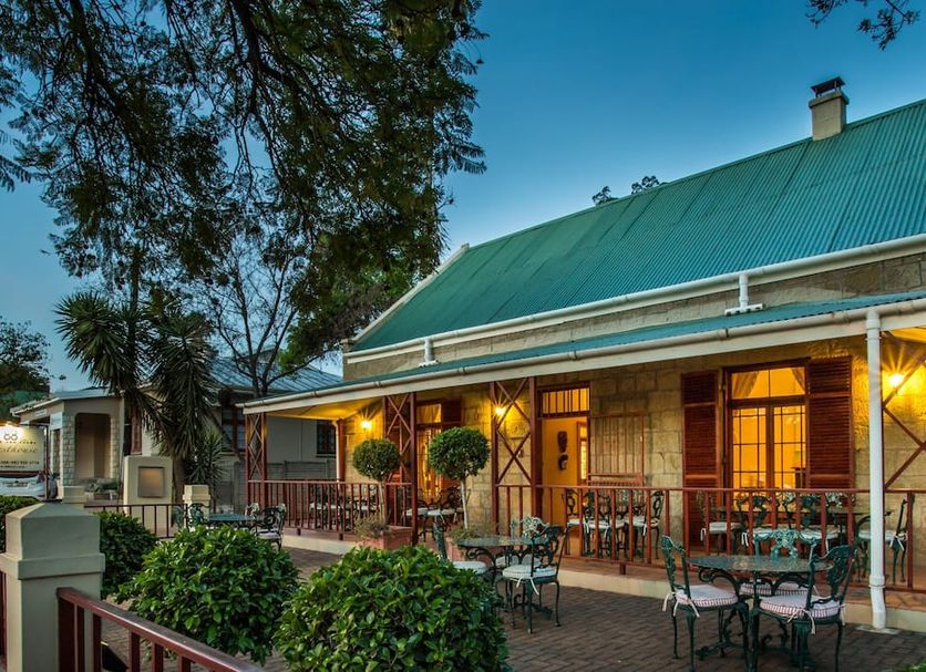 88 Baron van Reede Guesthouse in Oudtshoorn with a lit patio and outdoor dining area