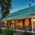 88 Baron van Reede Guesthouse in Oudtshoorn with a lit patio and outdoor dining area