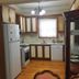 Penguen House & Bungalows in Sapanca: compact kitchen with wood cabinets, refrigerator, stove, sink, and glass cabinet