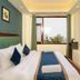 Hotel Woodrina in Shimla: bright guest room with twin bed, window view, and wall-mounted TV