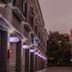 Guest Motel-Zhubei in Zhubei City, narrow hotel alley with lit signs and buildings at dusk