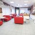 Lotus Hotel Istanbul lobby lounge with red seating, tables, and a coffee station