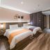 Home Inn Plus Foshan Shunde Qinghui Garden Rt-Mart guest room with two beds and wood flooring in Foshan